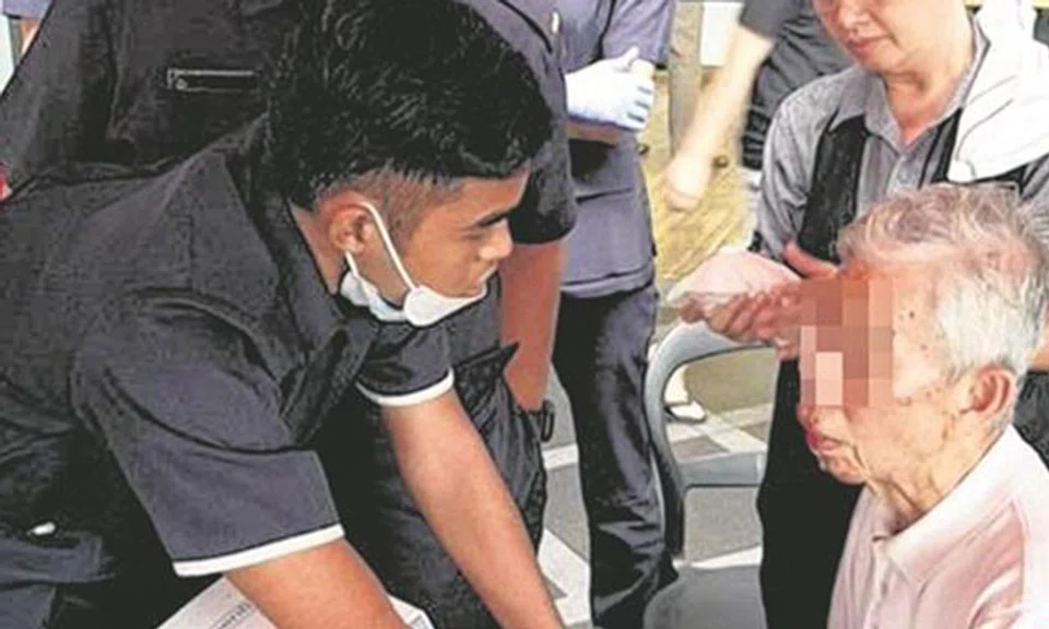 SCDF officers attending to Mr Huang Yiming (rightmost) who went missing for 26 hours.