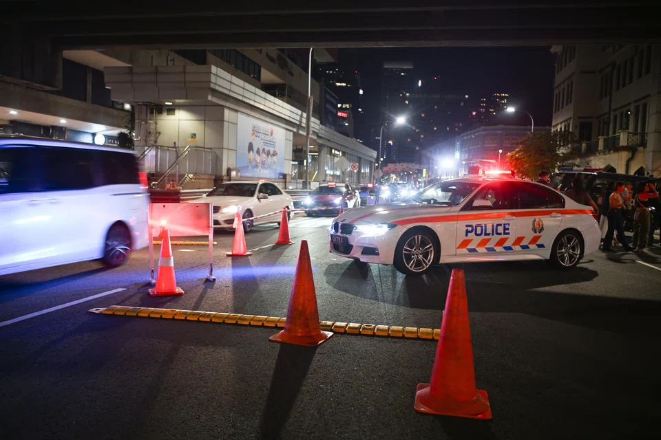 Traffic in Upper Cross Street's four lanes came to a near standstill as police screened motorists at a roadblock next to Chinatown MRT station on Sept 20.