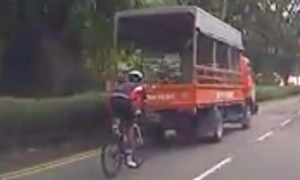 Another cyclist tired of living: He tailgates lorry and treats road like playground 