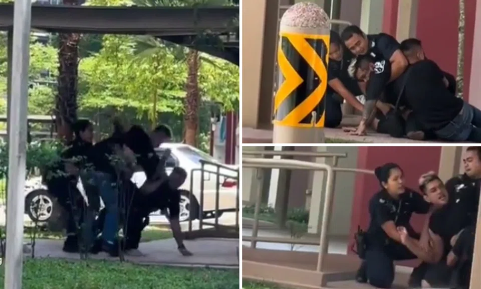 The video shared by Tiagong on Tuesday morning (Aug 8) shows three people trying to subdue a man with dyed hair in a sheltered walkway of an HDB estate.