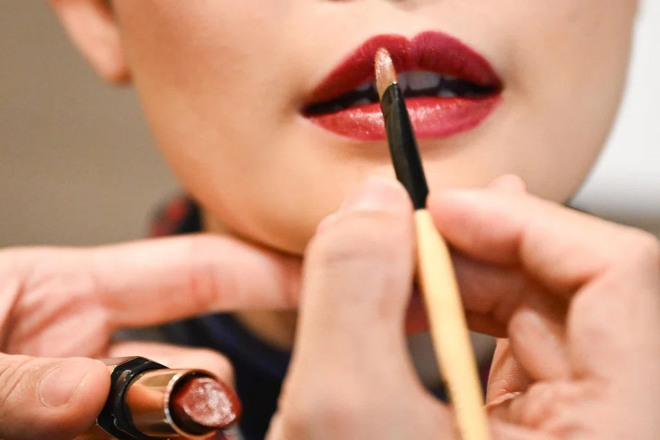 Lipstick being applied on Ms Lim.