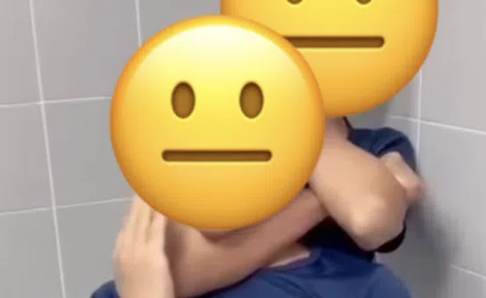 One student is held in a chokehold by his classmate.