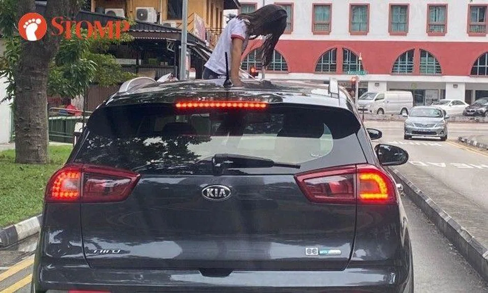 The car was at a traffic light junction, waiting for the light to change before turning into Balestier Road.