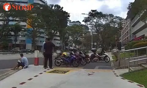 Several motorcycles park on double yellow lines, blocking pedestrian path near Serangoon Market