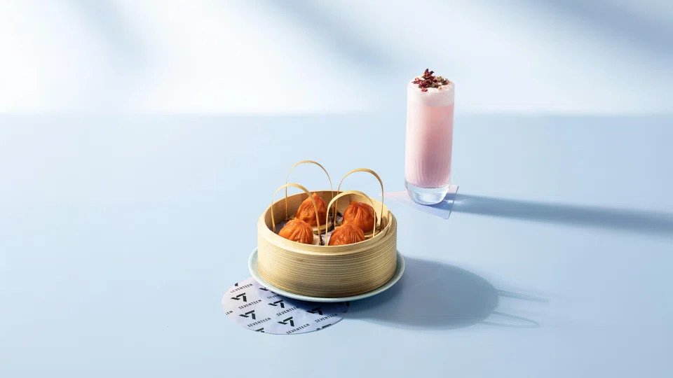 Mott 32's The Polished Trio bundle sees the restaurant's Hot & Sour Shanghainese Soup Dumplings served alongside its Wild Strawberry Fizz. PHOTO: MARINA BAY SANDS