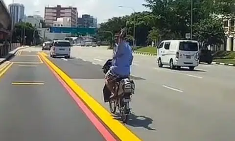 E-bike uncle beats red light and hogs lane -- then gives driver 'death stares'