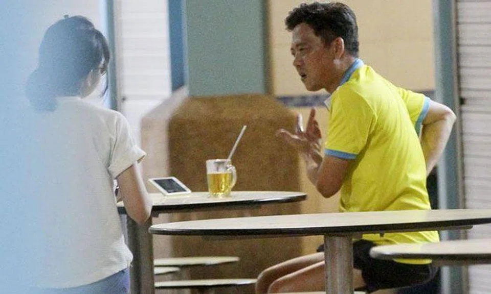 Mr Dominic Neo (right) talking to a a reporter. 