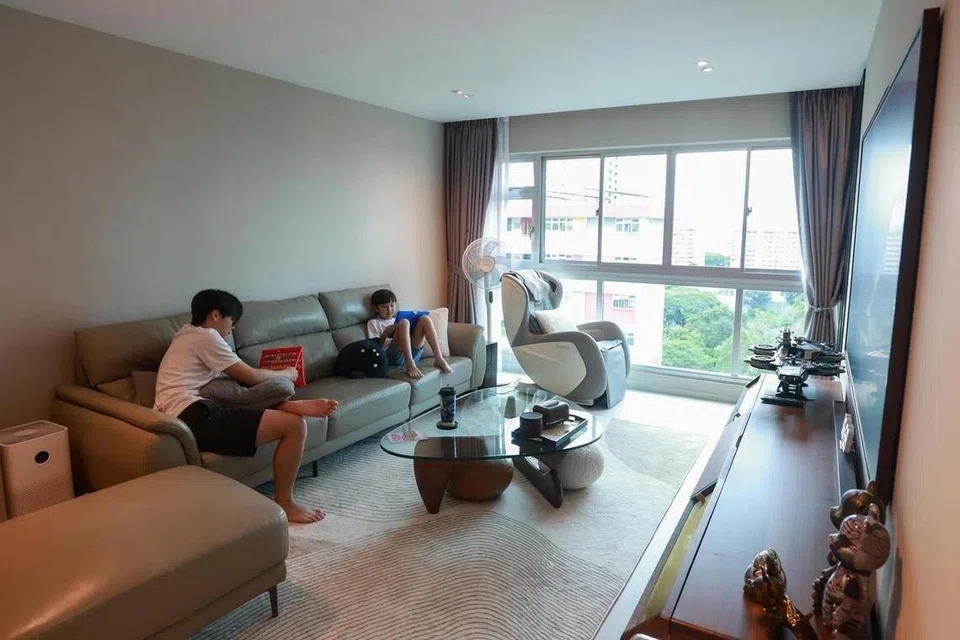 The living room remains spacious in the reconfigured flat. There is a separate dining area and gaming den.