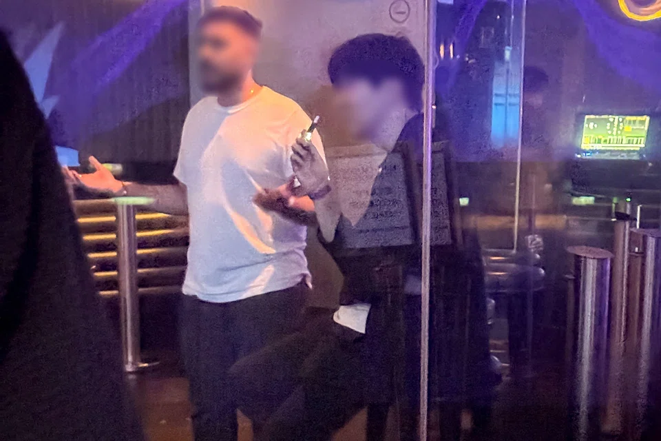 A man using an e-cigarette inside a smoking room at Marquee in Marina Bay Sands on Aug 23. Vape abusers will face increased fines from Sept 1.