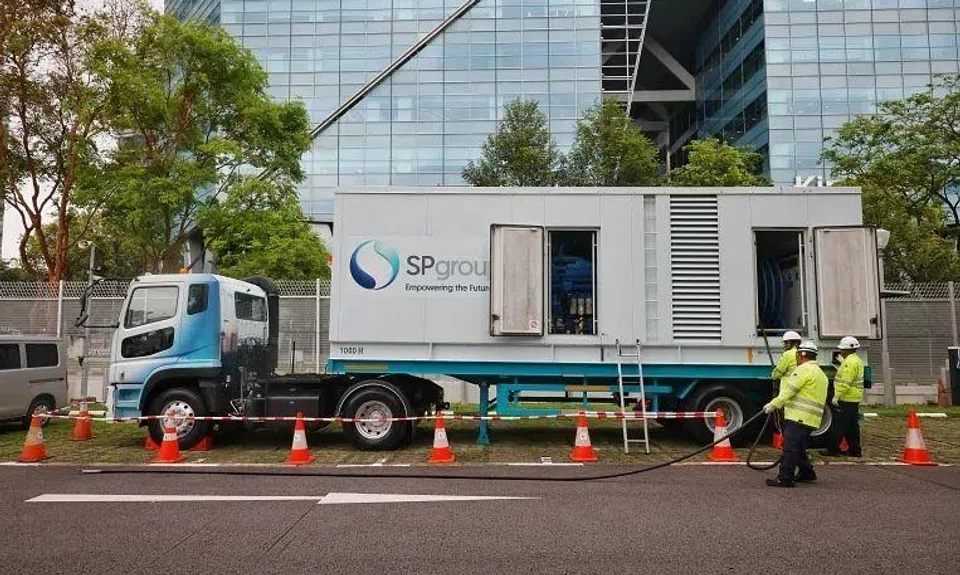 SP Group staff demonstrating how they set up a mobile power generator.