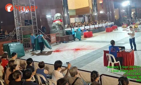 Red paint balls thrown near judge's table at lion dance competition outside Ngee Ann City