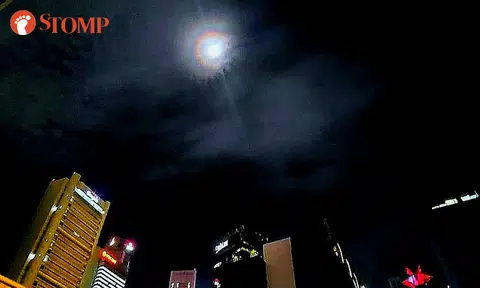 Man in awe of moon with beautiful rainbow halo that shone down on Singapore