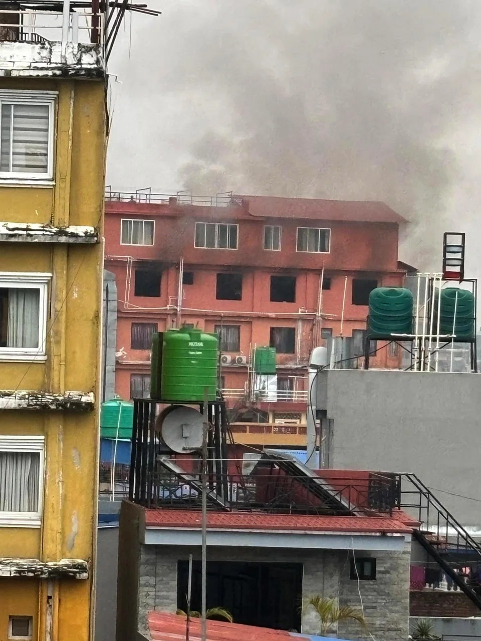 Thick smoke began billowing from the building opposite Ms Anna Yeow’s hotel in Pokhara on Sept 9. 