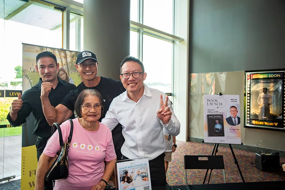 Mr Roger Tan with his mother and friends at his book launch in May.