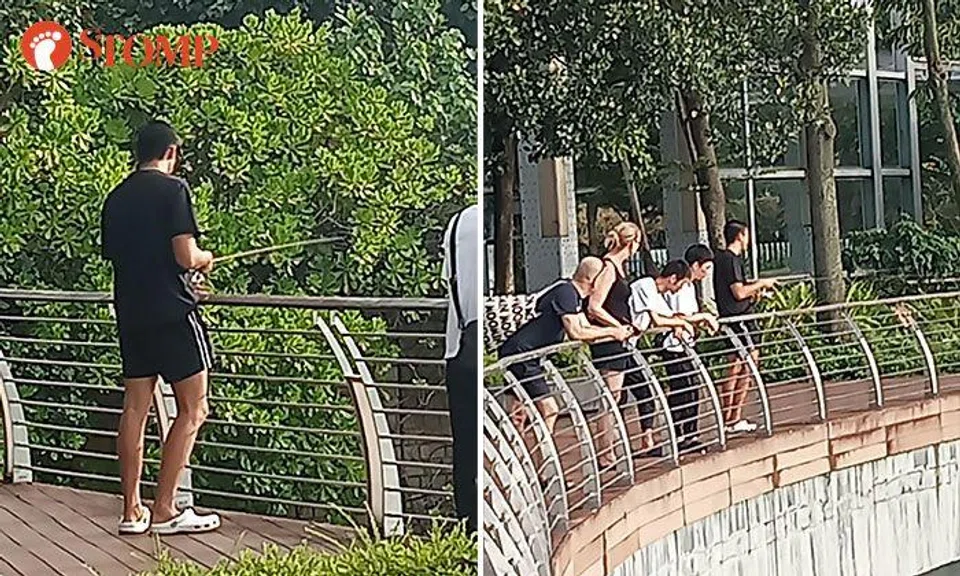 Man fishes along Sentosa Boardwalk even though it is strictly prohibited