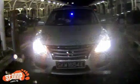 Nissan's driver signals to Stomper to exit -- then tailgates her to evade parking fee