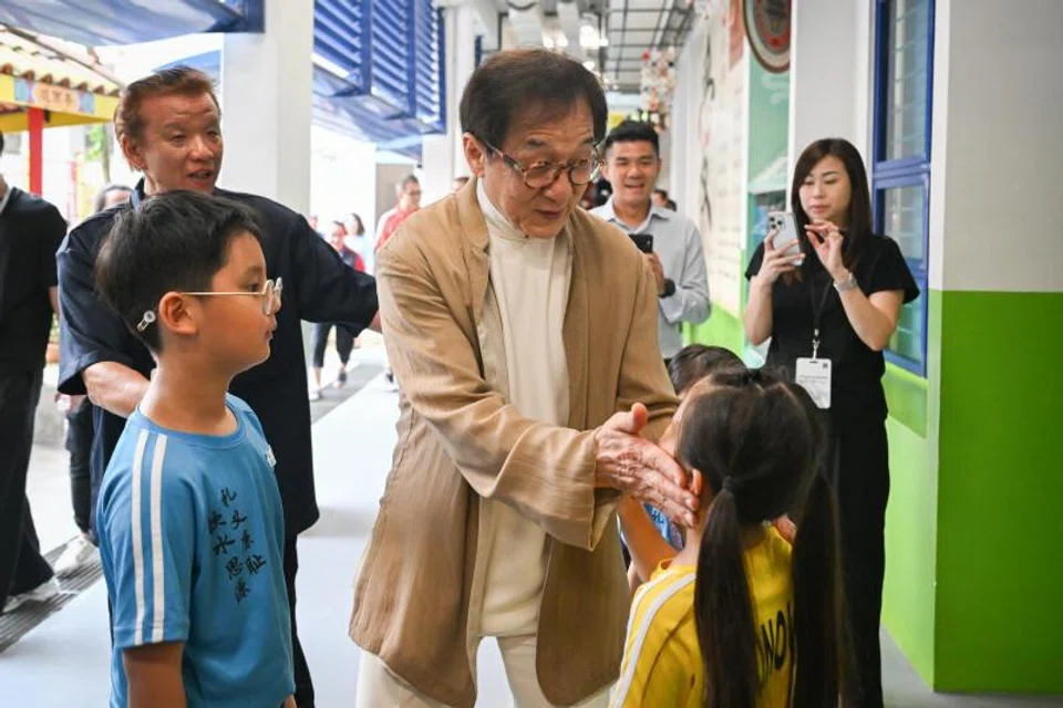 Jackie Chan interacting with pupils at Pei Chun Public School in Toa Payoh on July 7.