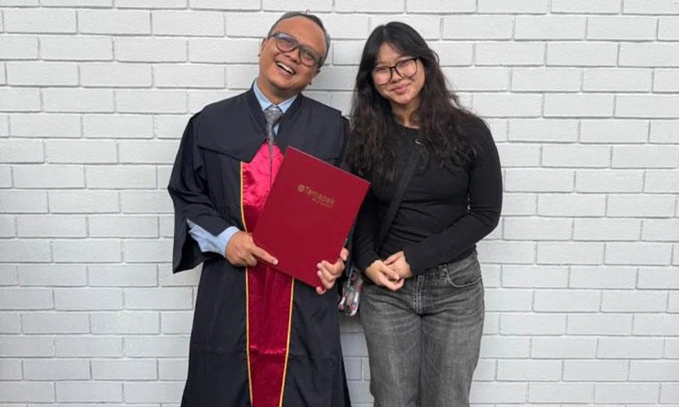 Mr Shaiful Khairi Mohammed Johari with his daughter Nur Amalina on his graduation day.