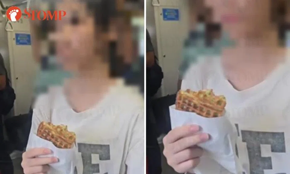 Passenger eating a waffle onboard the train towards Pasir Ris.