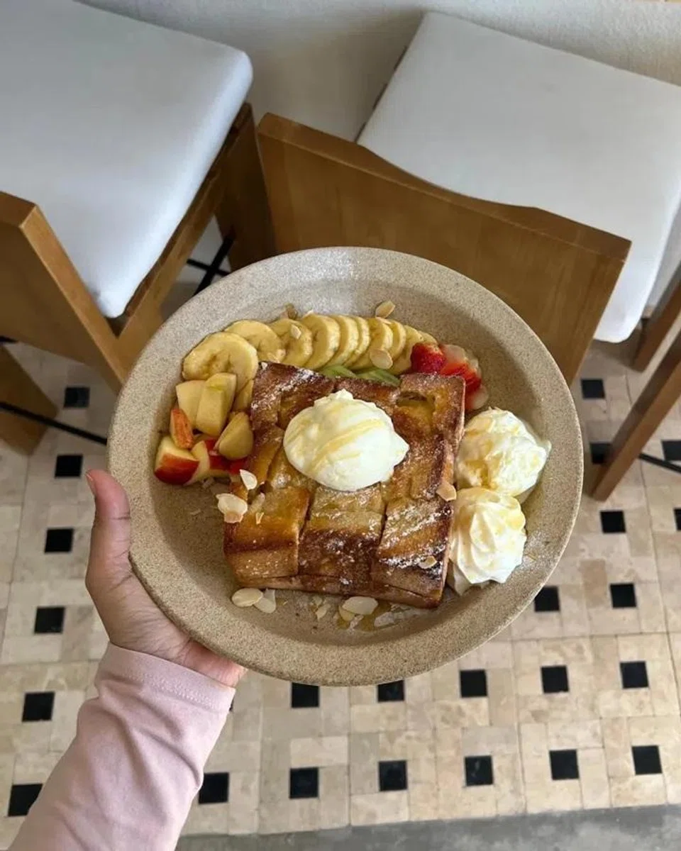 Among the dishes served at the new cafe Latitude 6 is mixed fruit honey toast.