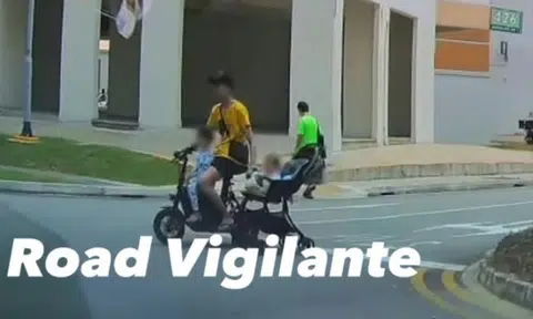 Man rides PMD while dragging baby pram along at Jurong West carpark
