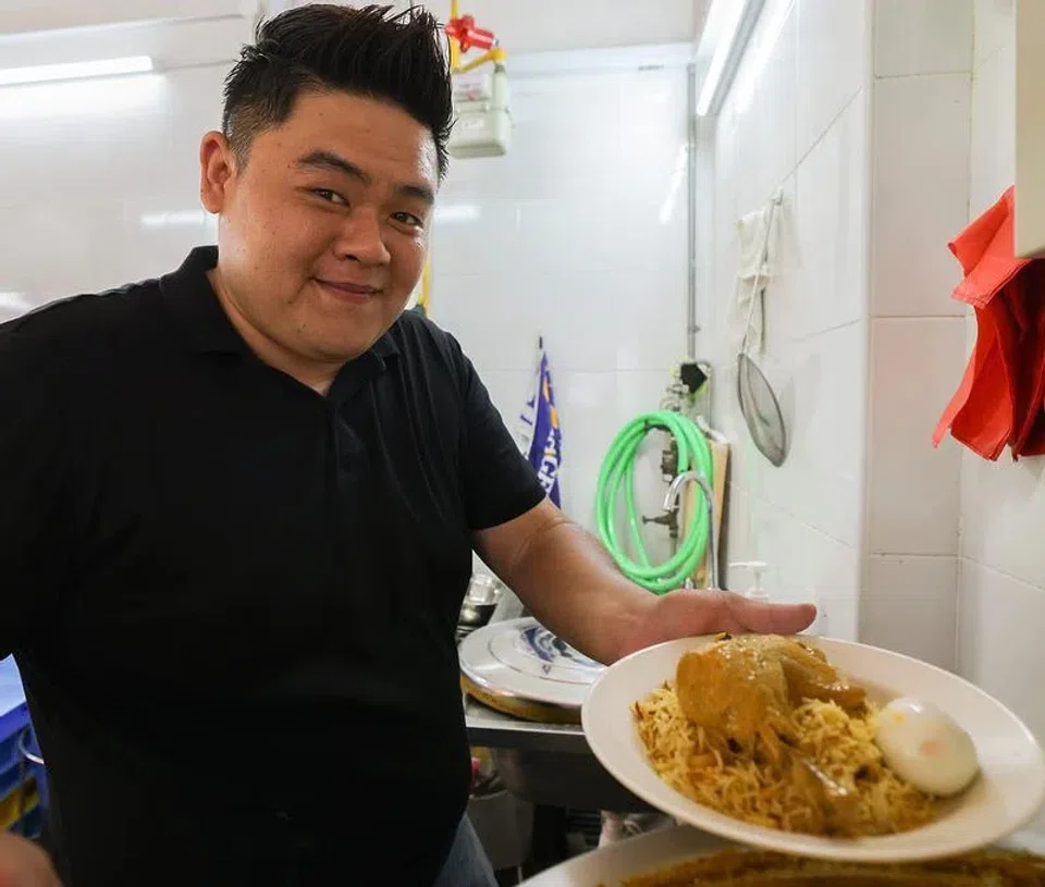 Mr Shaun Ho serving a plate of his $5 chicken biryani.