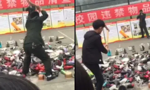 Chengdu students watch as school officials smash their confiscated electronic appliances with an axe
