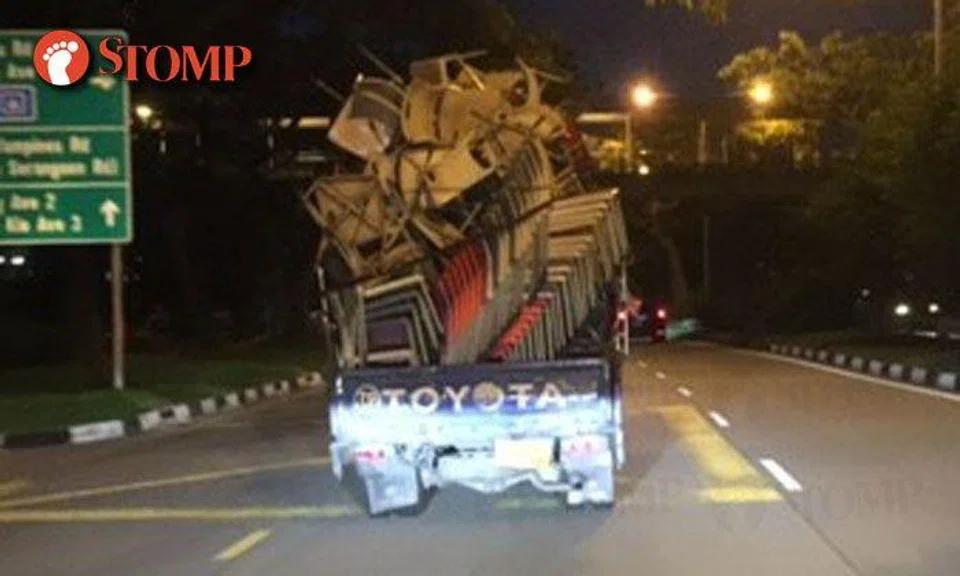 Stack of chairs sway dangerously on back of lorry driving down Hougang Ave 3