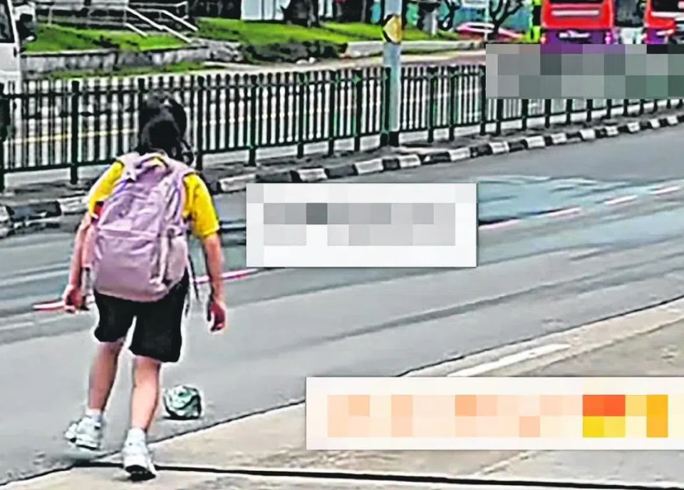 The girl ran on to the road to remove a rock that would pose a threat to drivers.