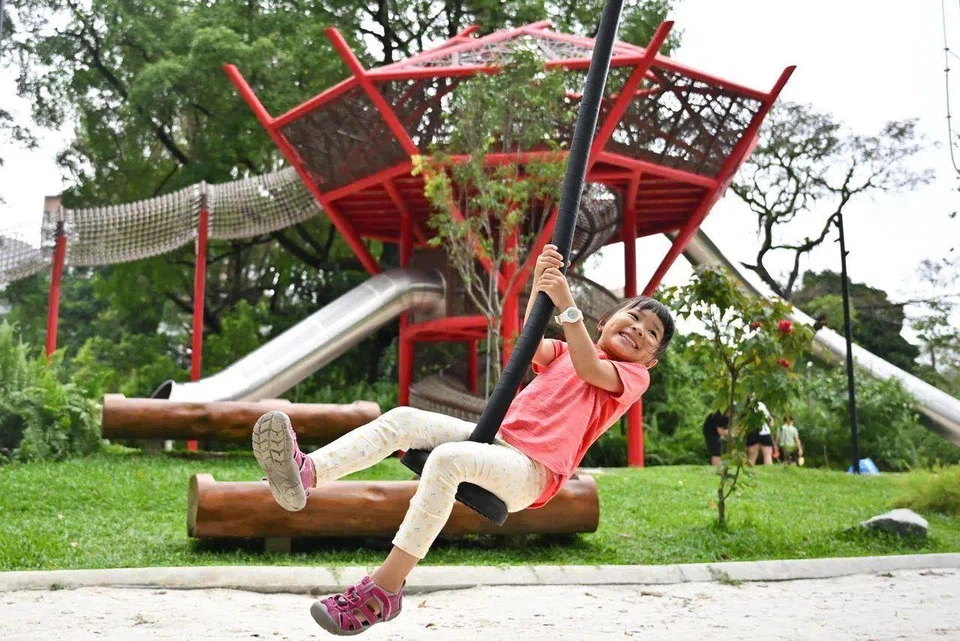 Five-year-old Aw You Chen soars through the air on a zip line near the "tree house" in Bidadari Park's Adventure Playwoods.