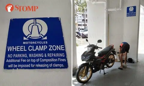 People are repairing their motorcycles in the void deck of a Teck Whye HDB block under a sign that says no repairing of motorcycles is allowed.