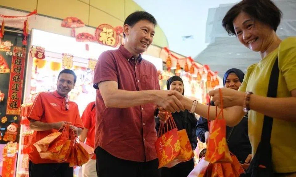 Transport Minister Chee Hong Tat giving out mandarin oranges at a community event on Jan 26.