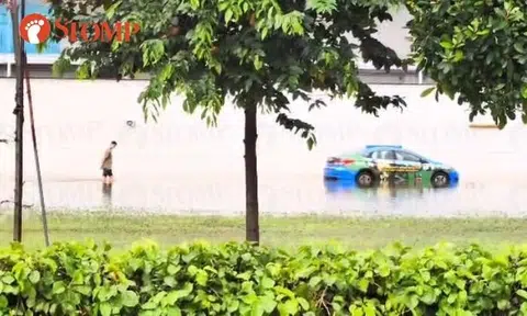Man wades through thigh-deep floodwater in Marina Bay area after monsoon surge: 'S'pore got river taxi?'