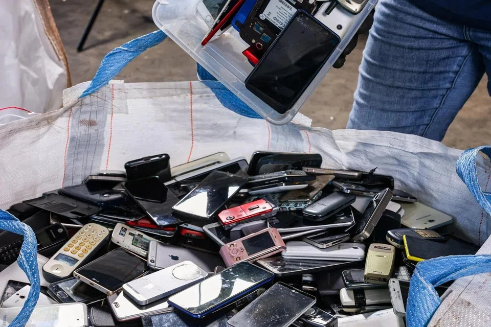 Old mobile phones collected by waste management firm Alba Group, which are sent for sorting and recycling. 