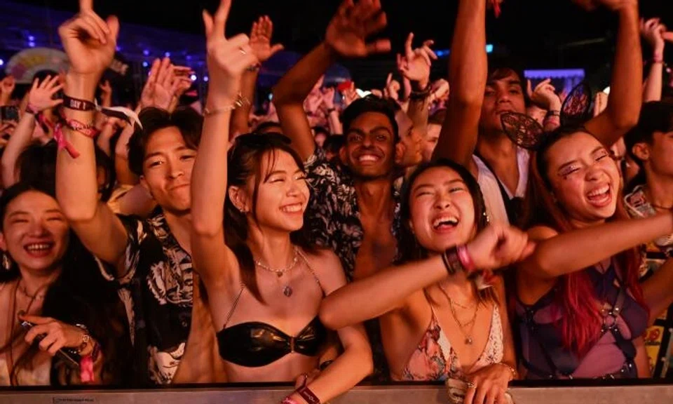 The crowd, many in their 20s and 30s, was mostly in front of a massive, brightly lit stage that featured giant LED screens and smoke machines.