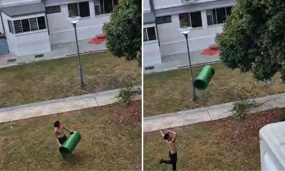 A shirtless man was spotted flinging a rubbish bin cover at a tree in an attempt to retrieve his phone.