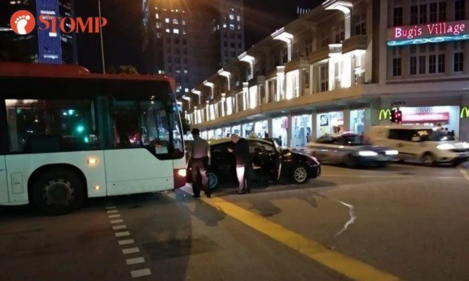 Bus and taxi hold up traffic after getting into accident along Queen Street