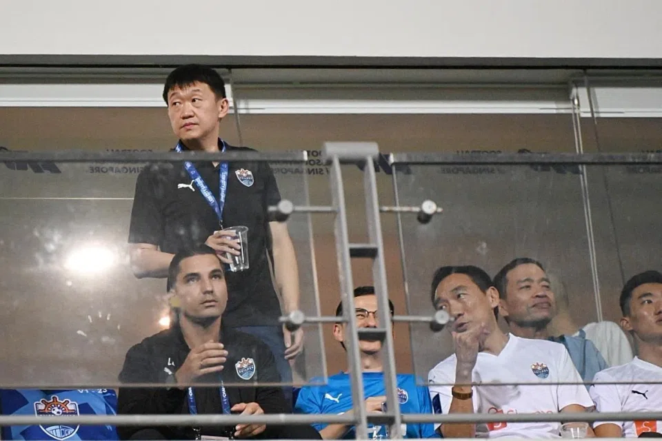 Tech billionaire Forrest Li (standing) watching the Lion City Sailors at Jalan Besar Stadium. on March 12.