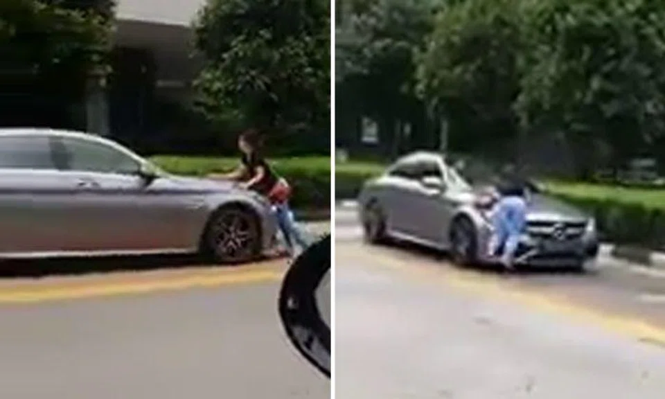 Woman blocks moving Mercedes in Bugis -- then leaps onto bonnet with legs dangling