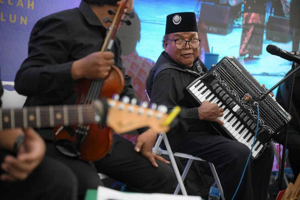 Mr Mohd Nazir Dolah performing with Orkes Melayu Mutiara, an intergenerational ensemble made up of islanders and descendants from Pulau Samulun, during Hari Orang Pulau at West Coast Park, on June 14. 