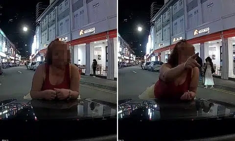 woman plants herself in front of car in bugis