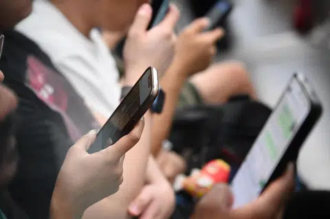 It is common to see commuters glued to their screens.