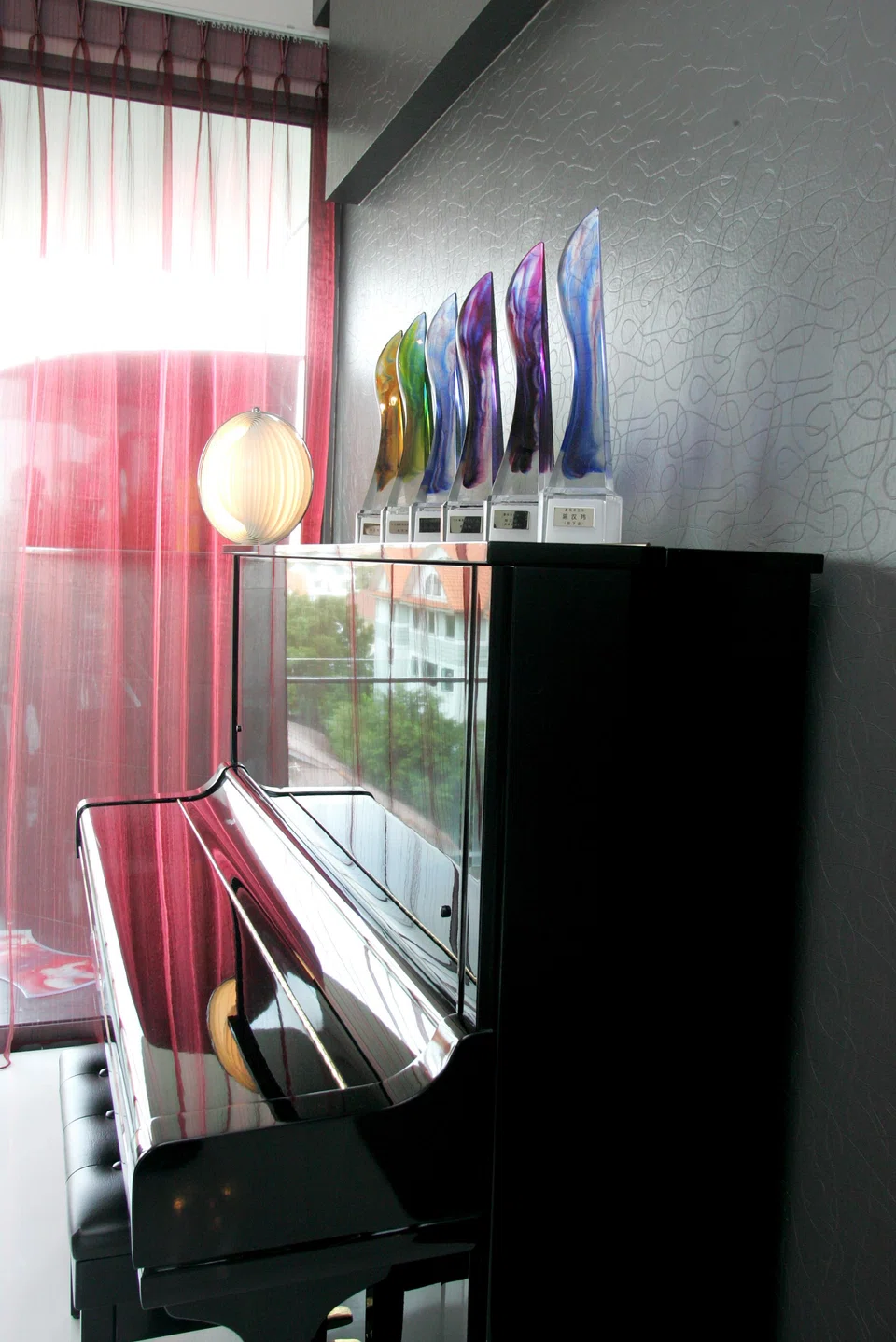 A 2006 photo showing the Star Awards actor Chen Hanwei has won displayed on a piano at his home. He has since won more awards.