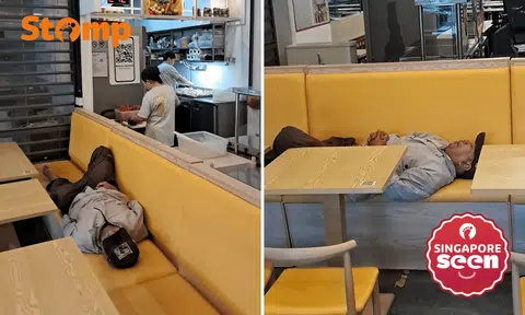 Man naps across restaurant seats at China Square Food Centre