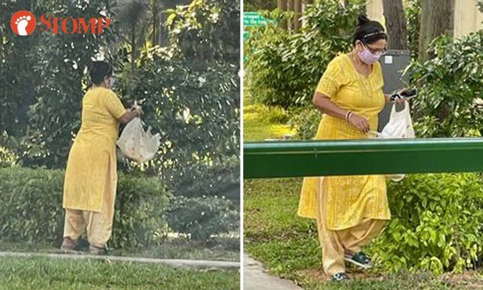 Woman cuts off flowers from plants in Serangoon, ignores passer-by who told her to stop