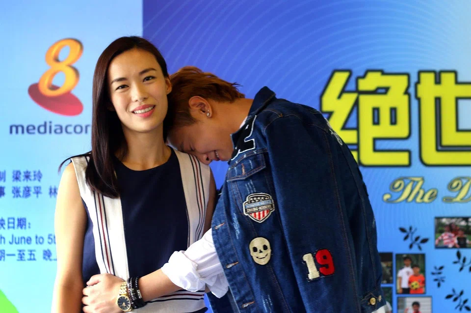 Fang (right) resting his head on the shoulder of local actress Rebecca Lim (left) in 2016. PHOTO: TNP FILE