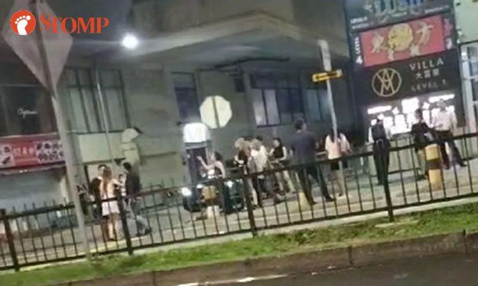 Women shout at each other in dispute over money outside Peace Centre