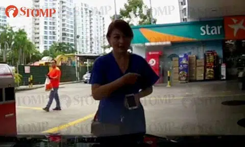 Woman blocks driver's way at Caltex Tampines while on the phone -- then scolds him for honking