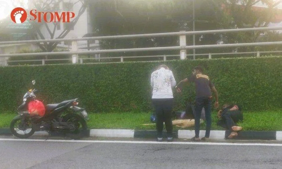 Stomper Johnny shared photos of the accident's aftermath, showing a man lying on the grass verge beside the road and passers-by who stopped to assist.