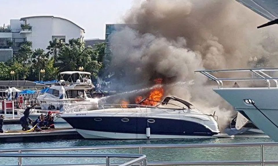 A photo taken by a passer-by shows the yacht engulfed in flames while berthed at the club.PHOTO: SHAZAN
